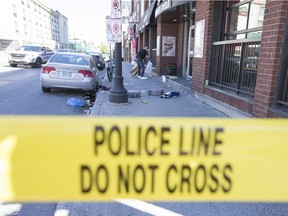 Investigators collect evidence after a homicide occurred along Dalhousie Street in the ByWard Market on the Canada Day weekend.