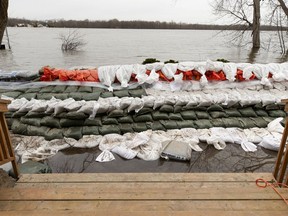 A dike holds back the water at the back door of a home in Pierrefonds on May 1, 2019.