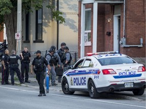 Members of the Ottawa Police Service at a crime scene on Lyon Street last week.