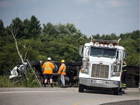 A tractor trailer driver took the turn on the offramp from 417 to Hunt Club too fast and rolled Saturday, July 27, 2019.   Ashley Fraser/Postmedia