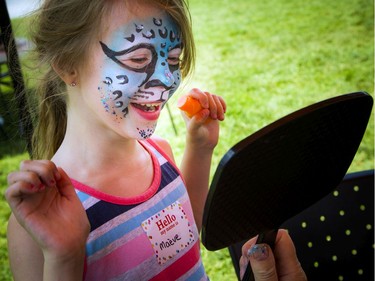 "Very Merry Unbirthday Party" celebrating children who struggle with friendships and don't always get invited to birthday parties was held in Larkin Park, Saturday, July 27, 2019. Maève Serviss who will soon be turning nine-years-old gets her face painted as a funky leopard.   Ashley Fraser/Postmedia