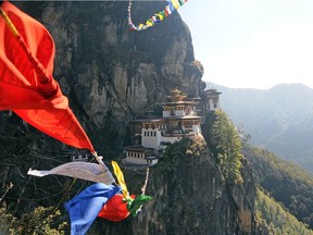 Prayer flags blow in the wind overlooking Taktsang Monastery, above the Paro valley in Bhutan. Dyed in five colours representing the elements, the prayers inscribed on such flags are thought to spread goodwill and compassion to all.