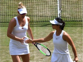 Gabriela Dabrowski of Ottawa and Yifan Xu of China celebrate winning a point in their women's doubles semifinal on Friday. After an unexpected day off Saturday, they'll play for a Wimbledon title on Sunday.