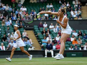 Gabriela Dabrowski of Ottawa, playing partner of Yifan Xu of China, plays an overhead shot during Sunday's Wimbledon women's doubles final against Su-Wei Hsieh of Taiwan and Barbora Strycova of the Czech Republic.