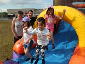 Sisters Katie Rallo (L), Abbie and Ellie (R) play at Vimy Ridge Public School, June 19, 2019.