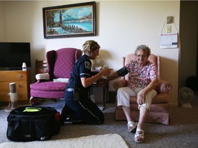 Stephanie Rose, a community care paramedic, looks after Maria Makkos, 82, during their initial consultation at Maria's home in Arnrprior, July 10, 2019.