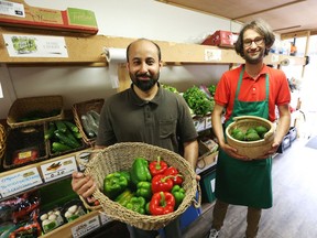 Faheem Khan, left, and Théodore Bisserbe show off some fresh offerings at the Market Mobile on July 11.