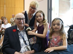 Reginald Wild, surrounded by his daughter, Carol, and great-granddaughters Léa, right, and Chloé Payette-Fox.