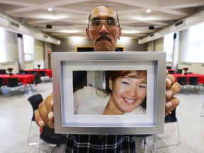 Tommy Papatsie holds a picture of his sister, Mary Papatsie, before Saturday's gathering to remember the woman who went missing in Ottawa in the spring of 2017.