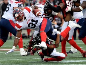 Alouettes running back William Stanback is tackled by Redblacks defensive back Sherrod Baltimore on Saturday, July 13, 2019.
