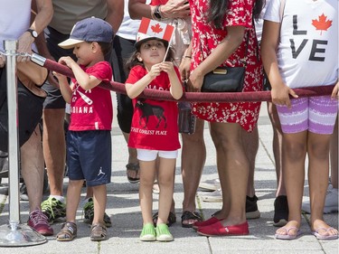 A youngster is focused on her Canadian flag as Canada Day activities are in full swing through out the downtown core.