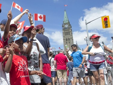 Kids gather for a photo along Wellington Street as Canada Day activities are in full swing through out the downtown core.