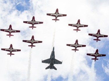 A CF-18 and the Snowbirds fly over centre town as Canada Day activities are in full swing through out the downtown core.