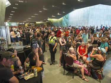 Music fans wait in the safety of the Canadian War Museum while the festival waits out the severe weather as the second day of RBC Bluesfest gets going on Friday evening.