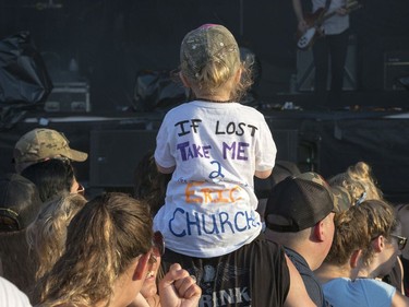 Raelynn Brisson-Coish, 2, wears a novel t-shirt sitting on her dad's shoulders watching Jason Isbell after the severe weather warning passed as the second day of RBC Bluesfest gets going on Friday evening.