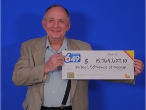 Richard Sobkowicz of Nepean displays the oversized cheque after he won $15,764,627.10 in the July 3 drawing of the Lotto 6/49.