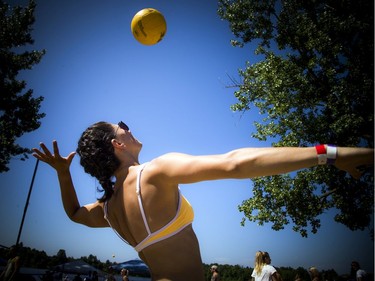 Laura Bianconi serves up the ball during HOPE Volleyball SummerFest that took place Saturday, July 13, 2019, at Mooney's Bay Beach.