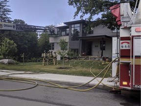 Ottawa Fire Services crews on the scene of a fire on Iona Street in Westboro on Sunday.