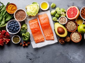 Healthy food clean eating selection: fish, fruit, vegetable, seeds, superfood, cereals, leaf vegetable.