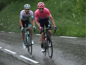Team EF Education First rider Canada's Michael Woods (R) attacks past Astana Pro Team rider Kazakhstan's Alexey Lutsenko during the seventh stage of the 71st edition of the Criterium du Dauphine cycling race, 133,5 km between Saint-Genix-les-Villages and Les Sept Laux-Pipay on June 15, 2019.