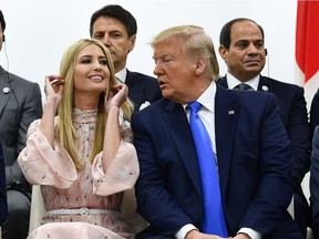 In this file photo taken on June 29, adviser to the U.S. President Ivanka Trump sits with her father during an event on women's empowerment during the G20 Summit in Osaka.
