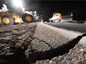 Highway workers repair a hole that opened in the road as a result of the July 5, 2019 earthquake, in Ridgecrest, California, about 150 miles (241km) north of Los Angeles, early in the morning on July 6, 2019. - Southern California was hit by its largest earthquake in two decades on July 5, a 7.1-magnitude tremor that rattled residents who were already reeling from another strong quake a day earlier.
