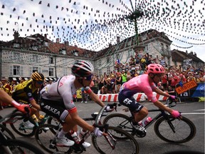 Ottawa's Michael Woods, right, rides through the town square in Arbois during Friday's seventh stage of the Tour de France.