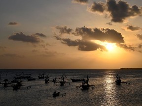 A fisherman rows his boat to go fishing in Kedonganan, near Denpasar on Indonesia's resort island of Bali on Monday.