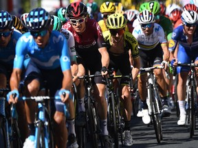 Great Britain's Geraint Thomas (3rdL) and cyclists ride in a group in the back of the race during the tenth stage of the 106th edition of the Tour de France cycling race between Saint-Flour and Albi, on July 15, 2019.