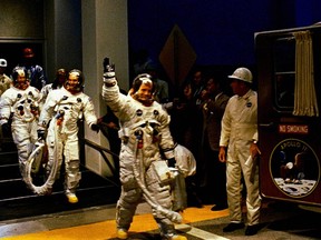 In this image obtained from NASA, the crew of the Apollo 11 lunar landing mission leave the Kennedy Space Center Manned Spacecraft Operations Building during the pre-launch countdown on July 16, 1969. - Neil Armstrong (C) is followed by Michael Collins, and Buzz Aldrin.