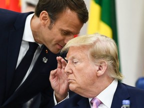 In this file photo taken on June 28, 2019 French President Emmanuel Macron speaks with U.S. President Donald Trump during a meeting at the G20 Summit in Osaka.