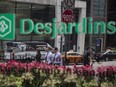 Pedestrians are seen reflected in the window of a Desjardins Group building in Toronto, Ontario, Canada, on Friday, May 19, 2017. Ontario is easing rules for its pension funds as years of low interest rates, poor equity returns and a looming retiree glut pressure companies. Photographer: Brent Lewin/Bloomberg ORG XMIT: 700055667