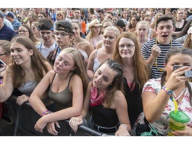 Fans of Gone West sing along with the group performing on the city stage following a severe thunderstorm that blew through Ottawa on day 7 of RBC Bluesfest. Photo by Wayne Cuddington/ Postmedia