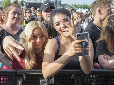 Michelle Nguyen (left) and Lynn Al-Helo having fun before Logic comes on stage on day 6 of RBC Bluesfest. Photo by Wayne Cuddington/ Postmedia