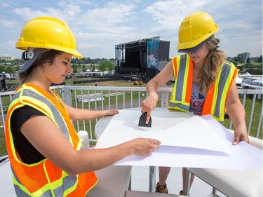 Bianca, left, and Kirsten prepare tables with branding in the VIP lounge as the 25th anniversary edition of Bluesfest gets ready to open.
