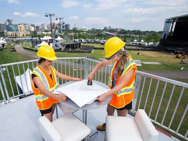 (from left) Bianca C. and Kirsten M. (no last names requested) prepare tables with branding in the VIP lounge as the 25th anniversary edition of Bluesfest gets ready to open on Thursday evening.  Photo by Wayne Cuddington / Postmedia
