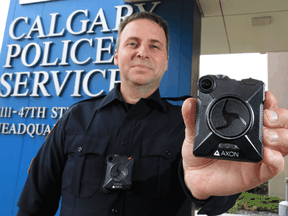 Calgary Police Service Staff Sgt. Travis Baker shows the service's new Axon body camera on July 3, 2018. Calgary's police force is one of the few in Canada to use the technology.