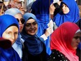 In this June file photo, people in Montreal protest Quebec's Bill 21, which will ban teachers, police, government lawyers and others in positions of authority from wearing religious symbols such as Muslim head coverings and Sikh turbans.