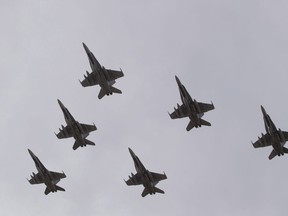 CF-18 Hornets fly in formation on their the departure for Operation IMPACT, in Cold Lake, Alberta on Tuesday October 21, 2014. Canada is officially asking four companies to send in their bids to supply a new fleet of fighter jets for the Royal Canadian Air Force. The 88 jets are to replace the country's aging CF-18s, which have been in service for more than 35 years.