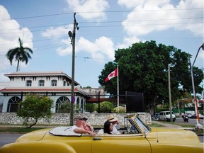 Tourists riding in a vintage car pass in front of Canada's Embassy in Havana, Cuba, May 9, 2019.