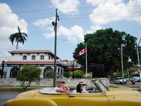 Tourists ride in a vintage car past Canada's Embassy in Havana. An early suggestion ascribing so-called 'Havana syndrome' among diplomats to 'mass hysteria' has now been generally dismissed.