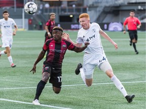 Christiano François, left, of Ottawa Fury FC and Camden Riley of Swope Park Rangers wait for the bouncing ball to return to turf level during in a United Soccer League Championship match at TD Place stadium in Ottawa, ON. Canada on July 20, 2019. Ottawa won 4-0.