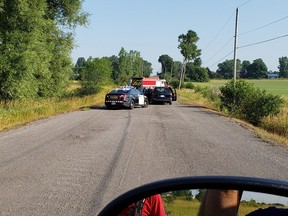 First responders line up on a rural road leading to a quarry where three men were found burning the plastic casing from several pounds of copper wire.