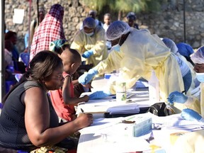 Congolese health workers collect data before administering ebola vaccines to civilians at the Himbi Health Centre in Goma, Democratic Republic of Congo, in mid-July.