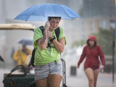 Volunteers and workers head to the Canadian War Museum as Bluesfest is delayed once again for a severe thunderstorm warning in Ottawa on Day 7 of RBC Bluesfest. Photo by Wayne Cuddington/ Postmedia