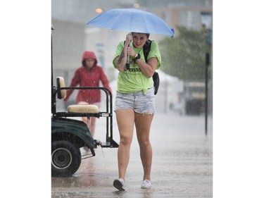 Volunteers and workers head to the Canadian War Museum as Bluesfest is delayed once again. Photo by Wayne Cuddington/ Postmedia