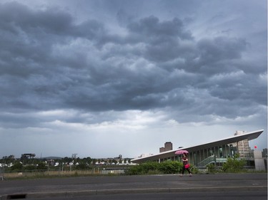 Large, black clouds drift over LeBreton Flats during a severe thunderstorm warning for Ottawa on Day 7 of RBC Bluesfest. Photo by Wayne Cuddington/ Postmedia