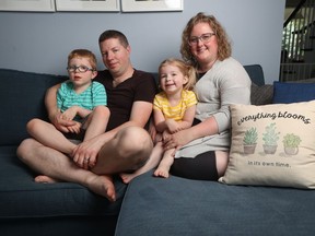 Kerry Monaghan sits with her husband Patrick and her two children Jack and Charlotte at her house in Ottawa Monday July 29, 2019. Both children are on the autism spectrum and receiving treatment.