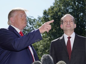 U.S. President Donald Trump announces the resignation of Labor Secretary Alex Acosta (R) before departing for travel to Milwaukee, Wisconsin from the South Lawn of the White House in Washington, U.S., July 12, 2019.