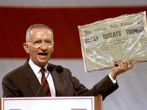 FILE PHOTO: Independent Presidential candidate Ross Perot holds aloft a copying of the 1948 Chicago Daily Tribune newspaper that declared Thomas Dewey the victor in the presidential race against Harry Truman, at a rally in Long Beach, California, U.S. November 1, 1992.